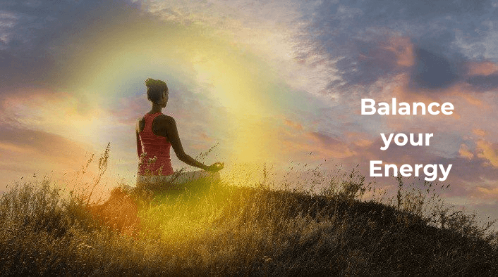 A silhouette of a woman meditating in a cross-legged lotus position on a grassy hill during a vibrant sunset, enclosed within a soft, glowing golden aura field.