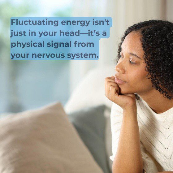 A pensive South African woman with curly hair resting her chin on her hand, looking thoughtful next to a light blue text bubble that reads: "Fluctuating energy isn't just in your head—it's a physical signal from your nervous system."